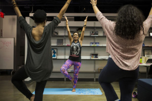 Yoga instructor Chanelle John leads a class at the teen center at Inquilinos Boricuas en Accion in the South End. (Jesse Costa/WBUR)