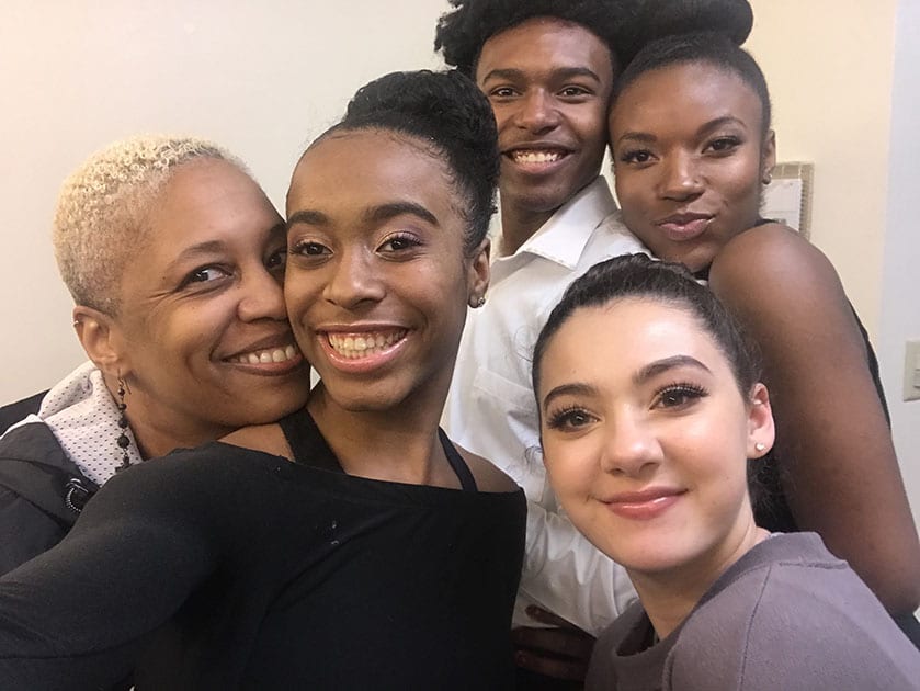 Greer Reed and her dance students smiling together